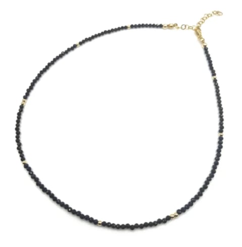 Black beaded necklace with gold-tone clasp and chain extender